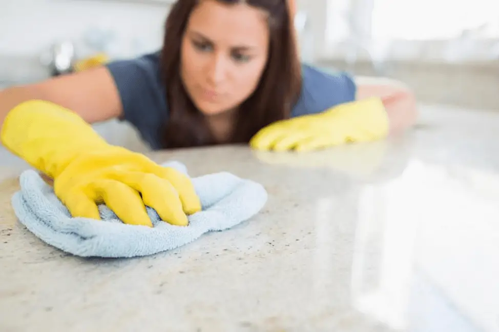Woman Cleaning Quartz Countertop
